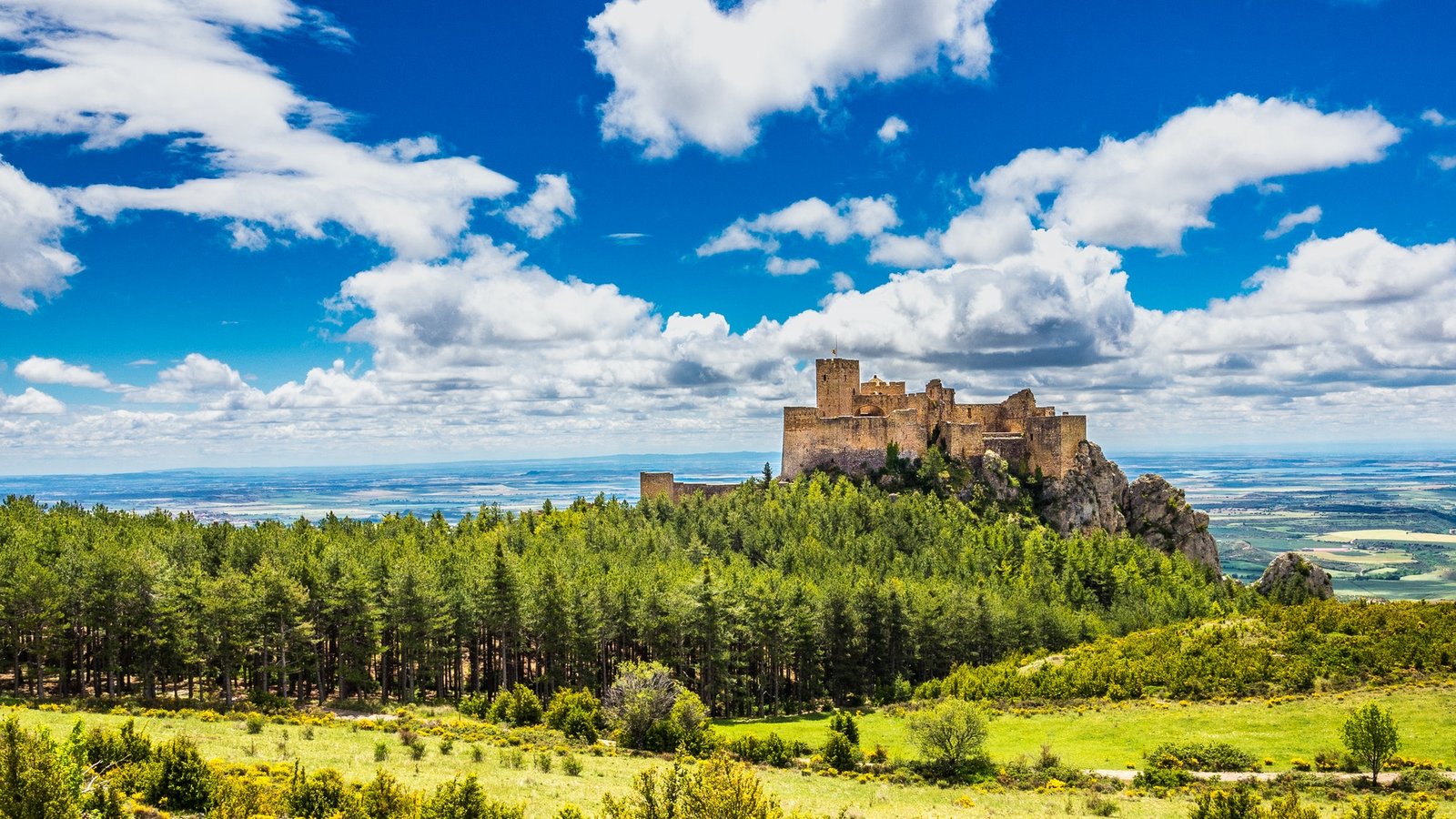 Scenic view of the famous Castillo de Loarre in Aragon, Spain under a cloudy sky background